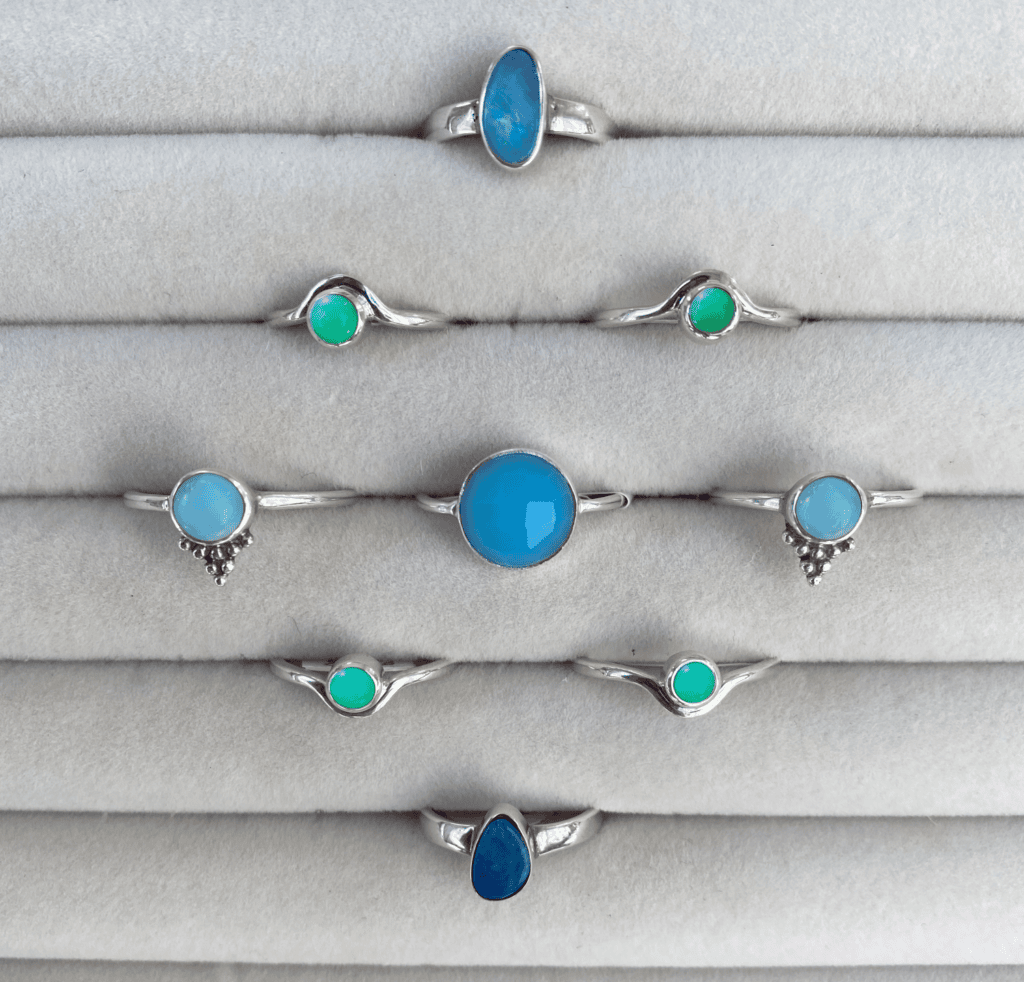 an assortment of sterling silver gemstone rings including Australian Opal, green chrysoprase, blue chrysoprase